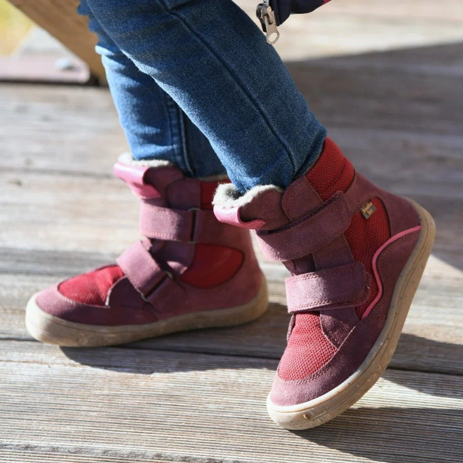 Froddo barefoot Tex winter boot in red worn by a young child outside