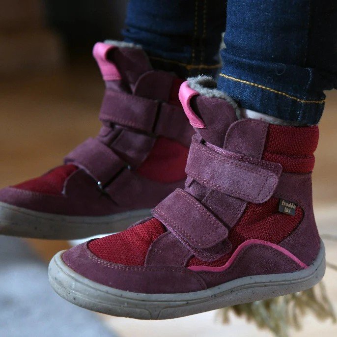 Side profile close up view of a pair of barefoot kids winter boots, the Tex by Froddo with velcro closure