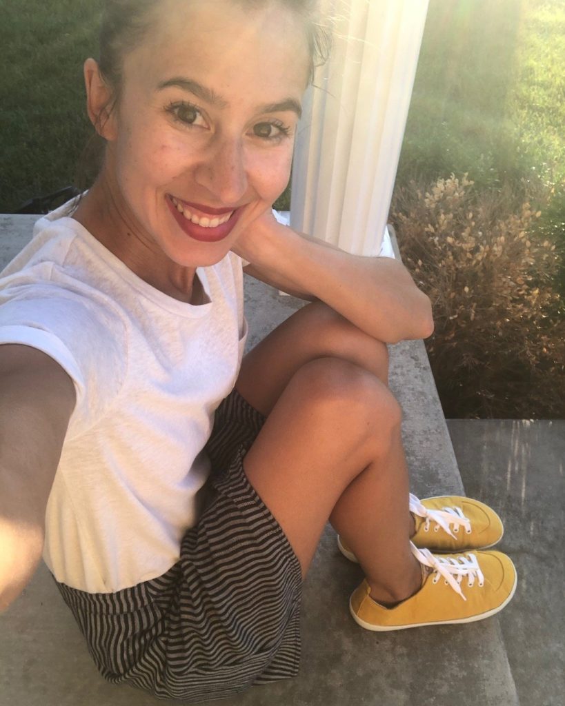 A woman wearing vegan barefoot shoes from mukishoes - canvas Sol sneaker