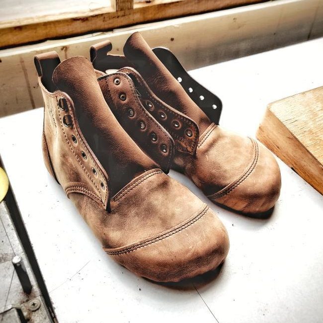 a close up of a pair of gaucho ninja minimalist handmade work boots sitting on the table