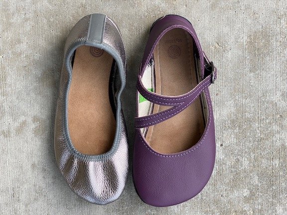 A top down view of two different Softstar shoes side by side: the Ballerine in pewter and the Primal Merry Jane in Elderberry