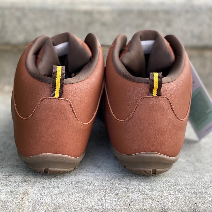 a close up of a pair of vegan freet mudee brown sitting on concrete with the heels visible for the best barefoot minimalist hiking boots review