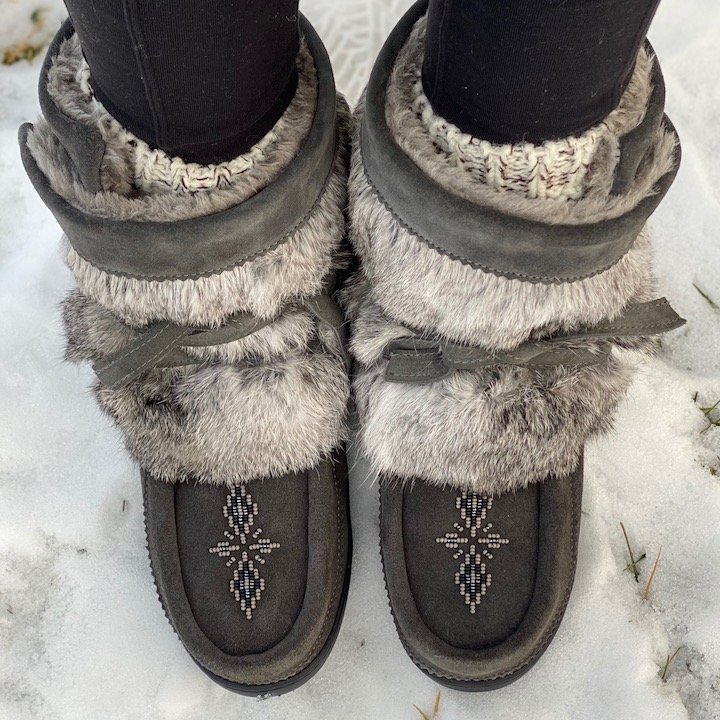 Top view of a woman's legs in Manitobah Mukluks short wrap fur winter boots