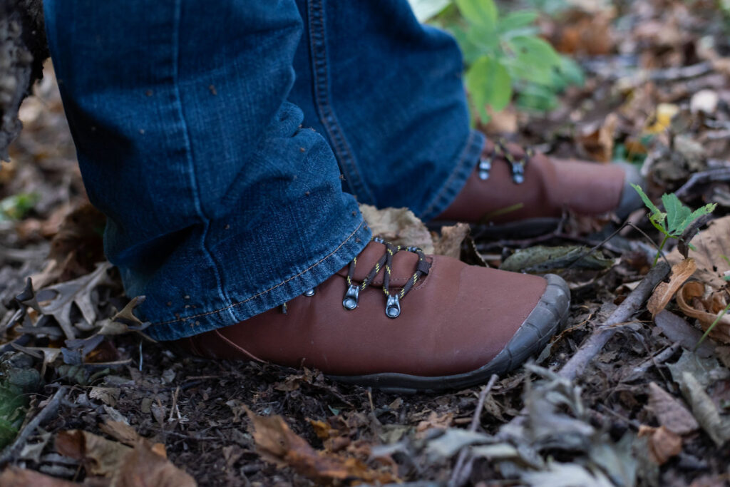 A pair of feet in nature wearing Freet Mudee Barefoot vegan hiking boot