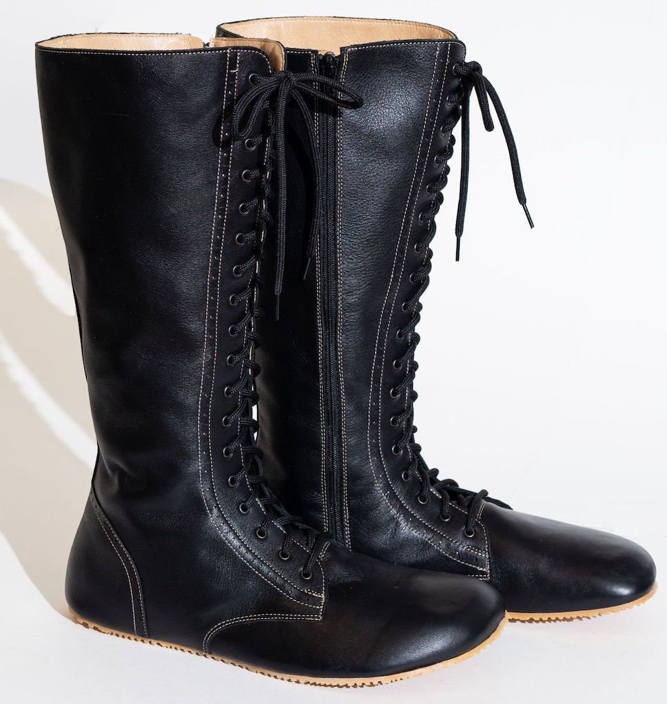 A stock image of a pair of No(N)s tall black leather lace up barefoot combat style boots.