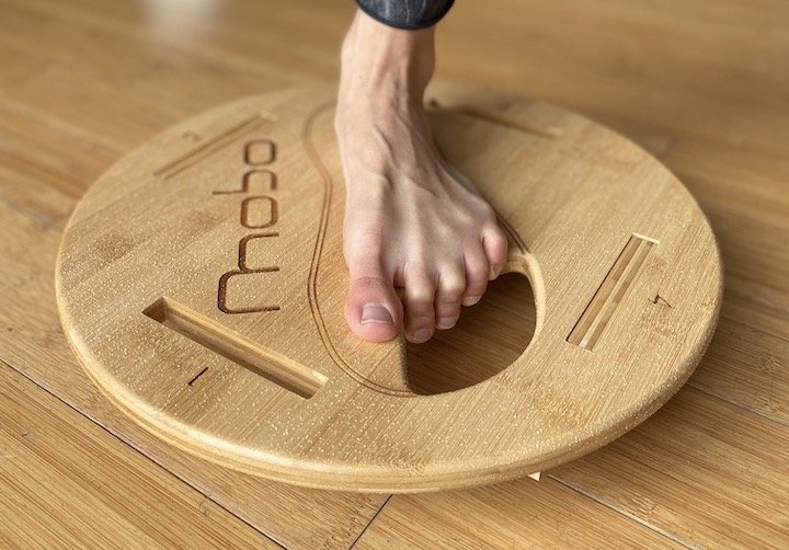 A close up front view of a woman's foot on the Mobo balance board, designed to strengthen balance skills.