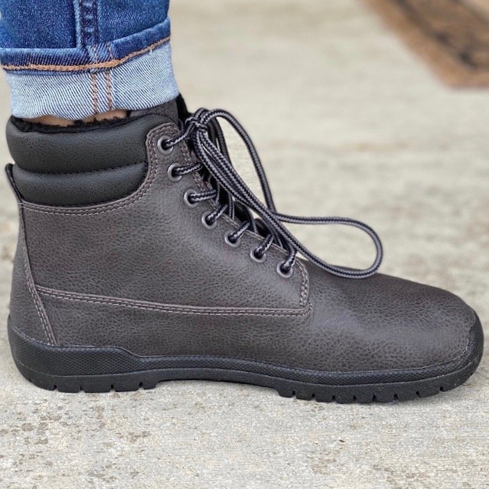 A side view of a high volume foot wearing Feelgrounds patrol Winter boot.