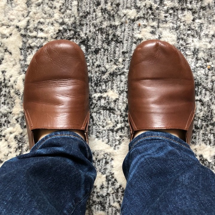 FeetSutra brown leather shoes with creases and scuffs visible.