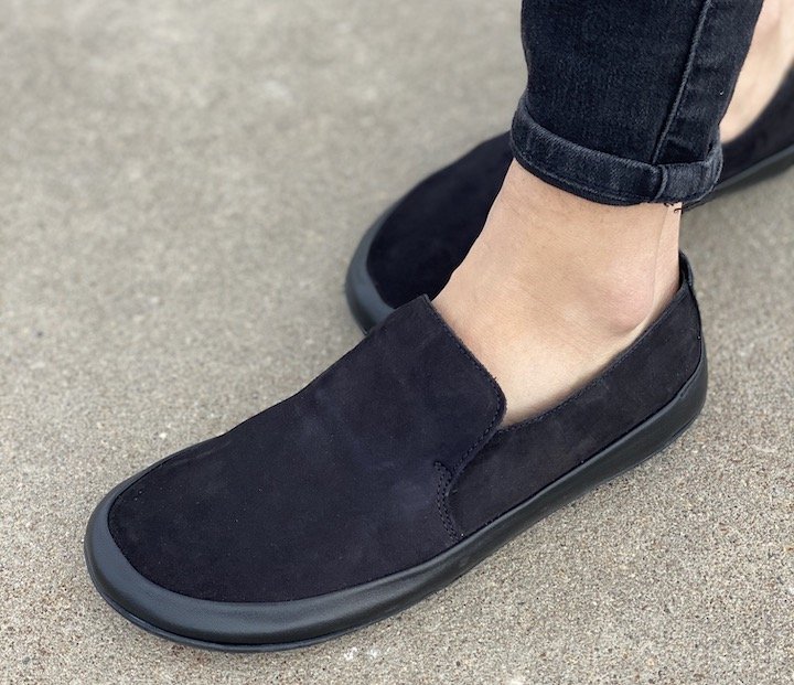 A front angled view of Vivobarefoot Opanka Black leather super soft and flexible barefoot loafers.