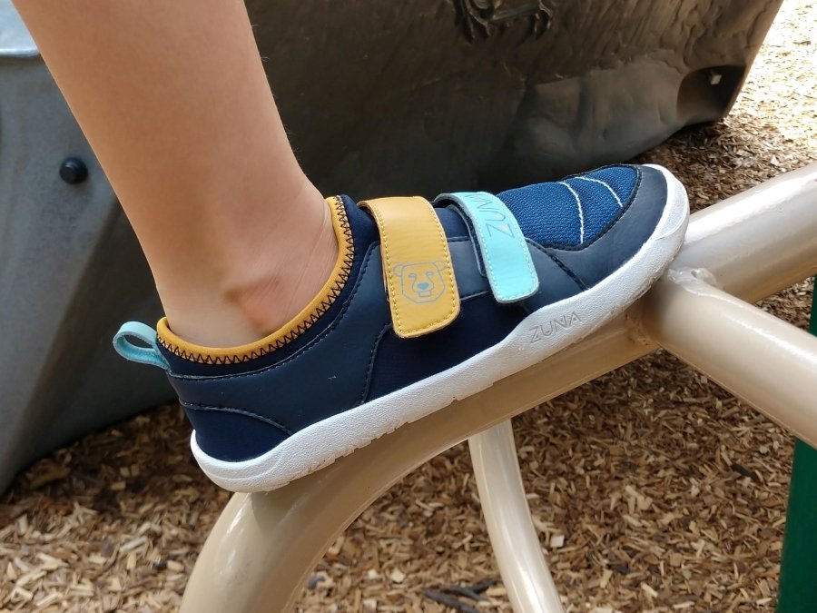 Zuna Shoes Akili Side view of Big kid vegan barefoot sneakers at the park