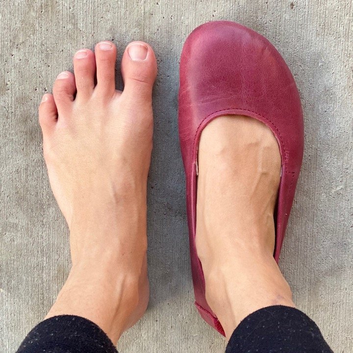 Close up top down view of a woman with wide feet wearing one Angles Fashion Afrodita flats on her right foot. It features a wide toe box, and zero drop sole