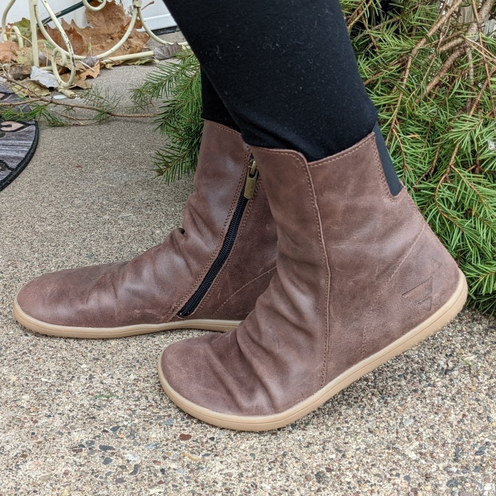 A pair of Angles Fashion Dafne boots in Coffee brown leather being worn with one foot flexing the boot.