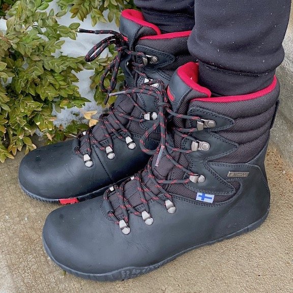 A side view of a person wearing a pair of Feelmax Kuuva black barefoot waterproof hiking boots