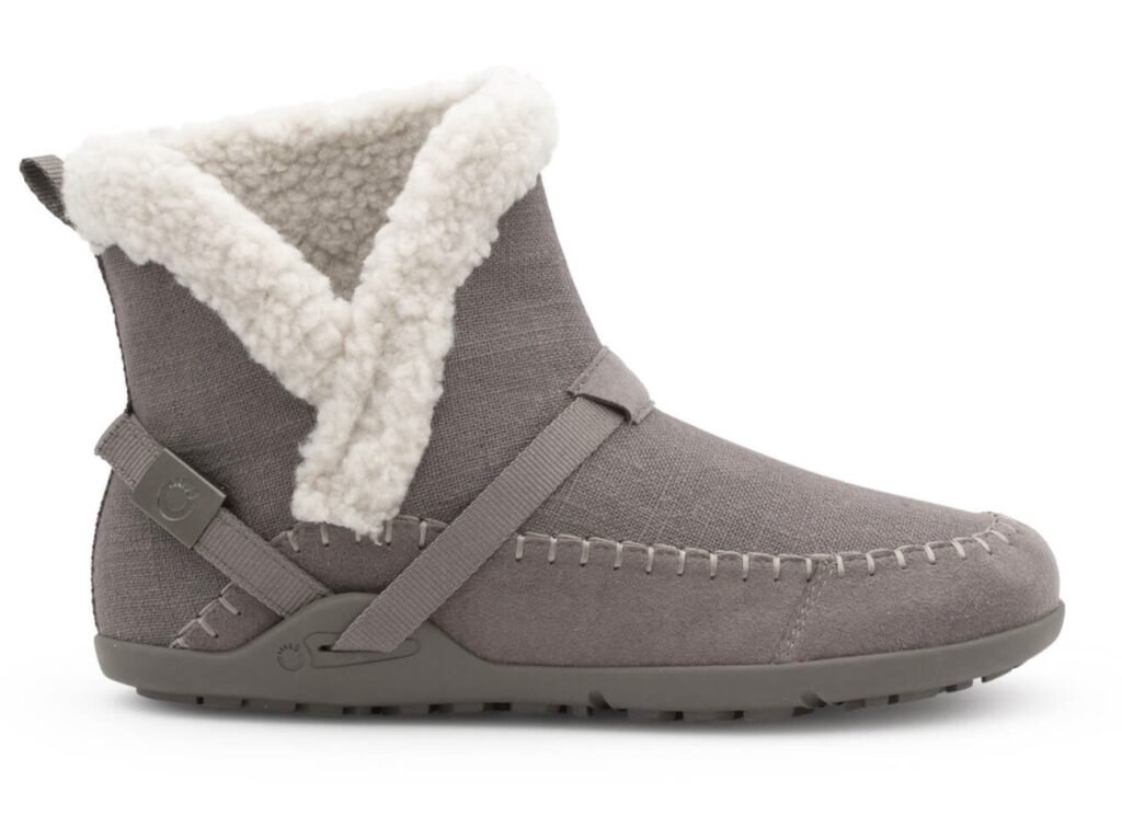 A side view of the Xero Shoes Ashland vegan faux shearling barefoot bootie for women with a white background