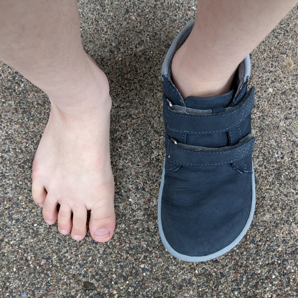 Top down view of a wide kids foot wearing one Be Lenka Jolly Barefoot kids sneaker with an extra wide toe box