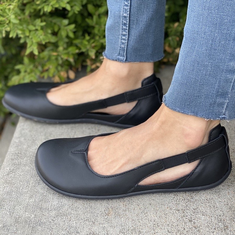 Side view highlighting the cutout sling back style feature of Be Lenka Bellissima black leather ballet flats.