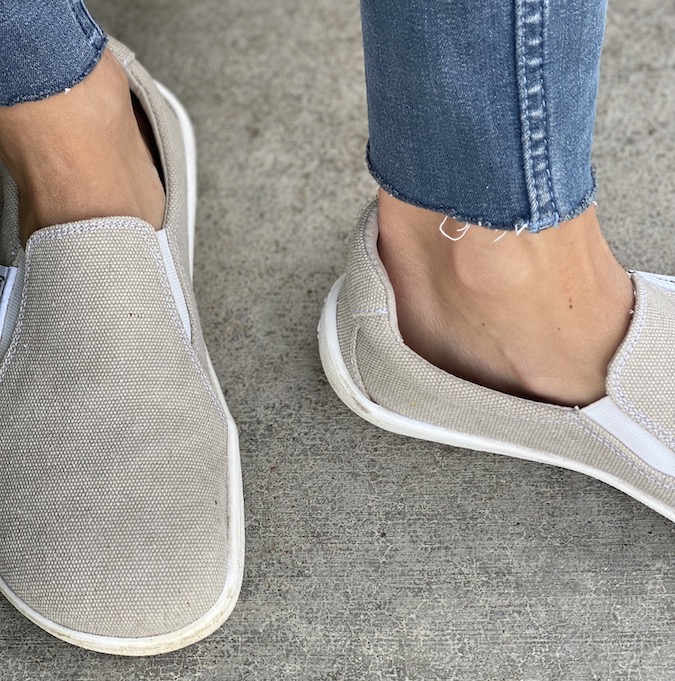 Close up of a pair of feet in Be Lenka Eazy slip on barefoot sneakers, showing the front and side ankle areas on low volume feet