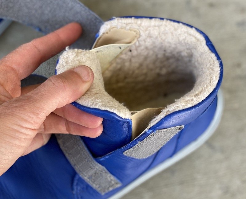 A close up view of a Be Lenka Panda barefoot winter bootie for kids showing the fur lining and attached tongue