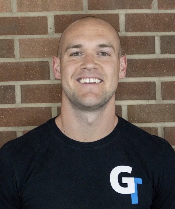 A close up headshot of Graham Tuttle white male smiling at the camera