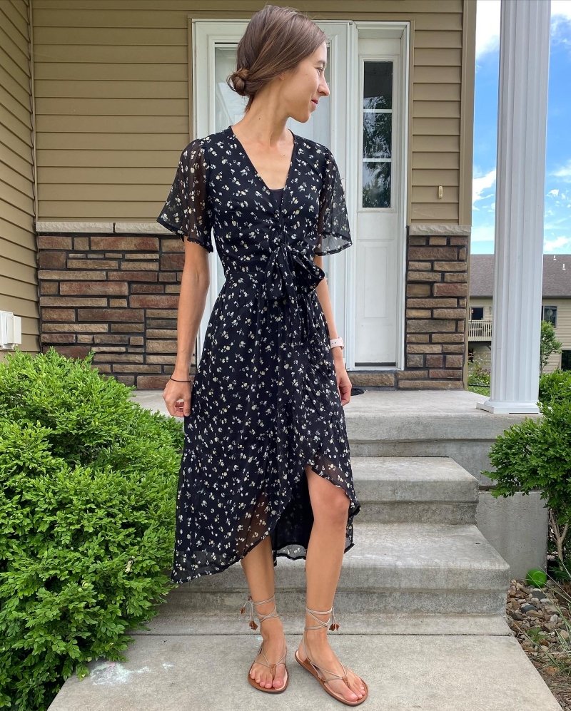 Magical Shoes Moana Sandals styled by a woman with brown hair wearing a black patterned hi-low flowy dress