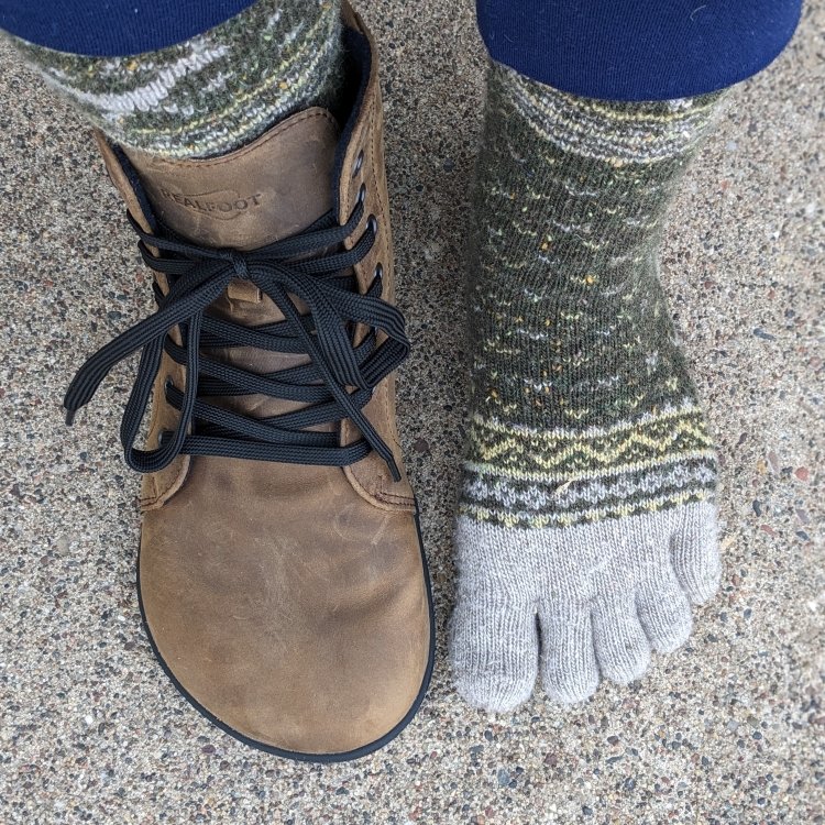 Top down view of RealFoot Farmer Boot next to an extra wide foot wearing Knitido toe socks. There is ample toe space for splay in RealFoot shoes