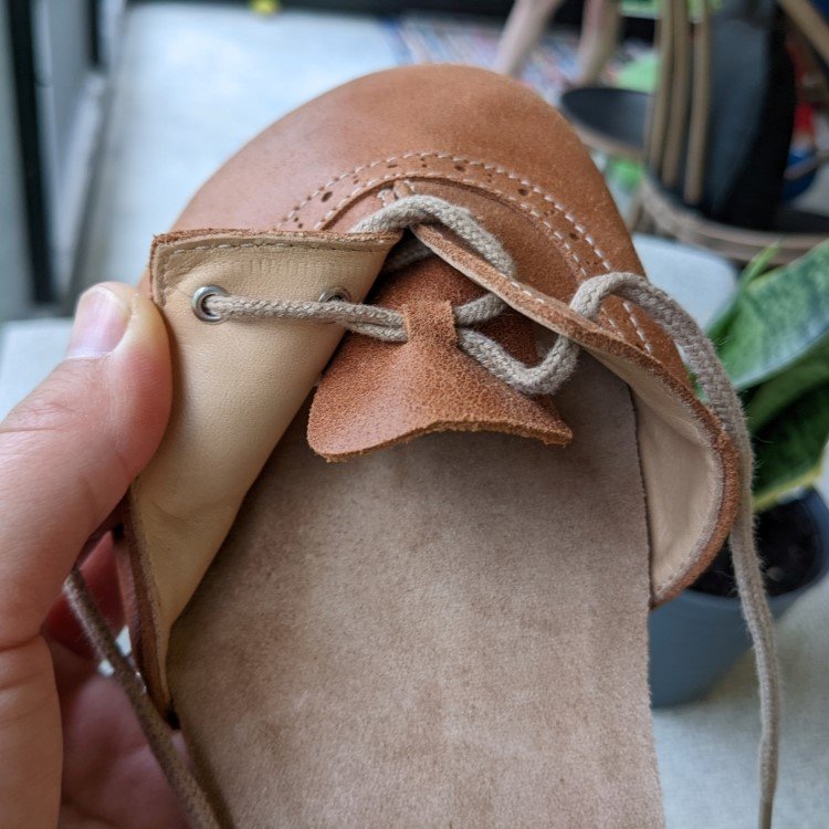 Close up of the adjustable laces on NoNs summer sandal barefoot closed toe sandals with charming details