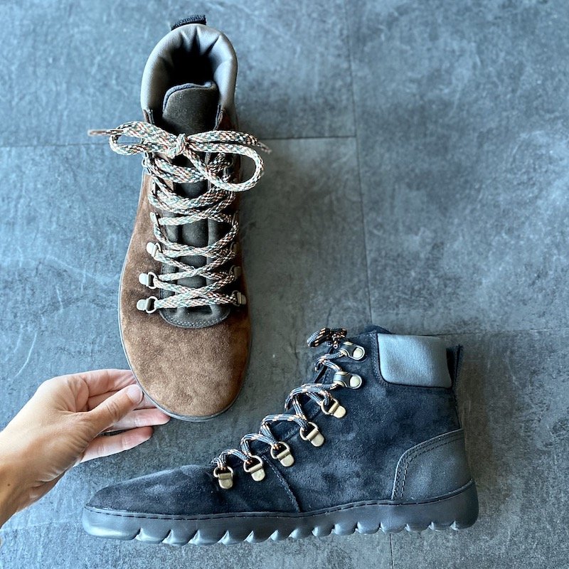 A close up of a brown and a black Groundies Barefootwear Tegernsee Barefoot boot for fall and winter 2022