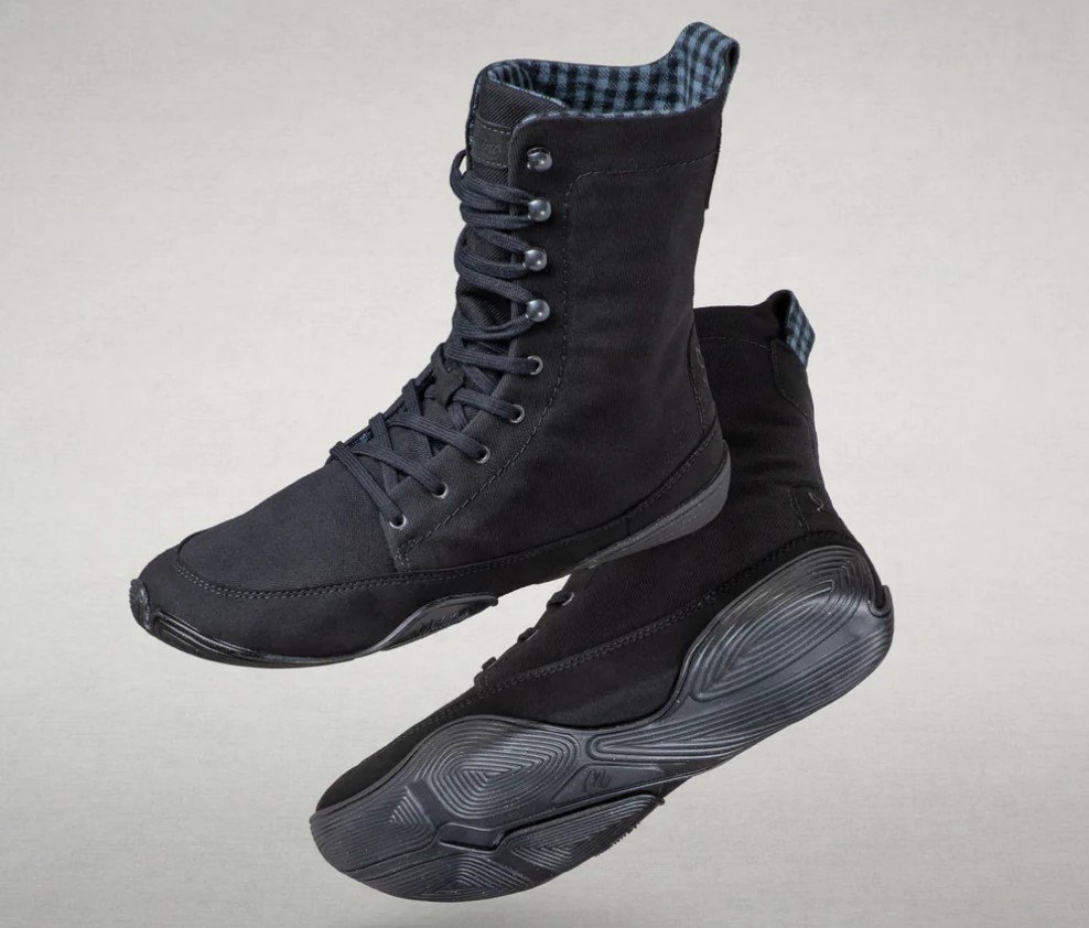 Stock image of tall Wildling Shoes vegan black twill winter boot with speed hooks, hemp flax fleece lining,  and a zero drop sole.