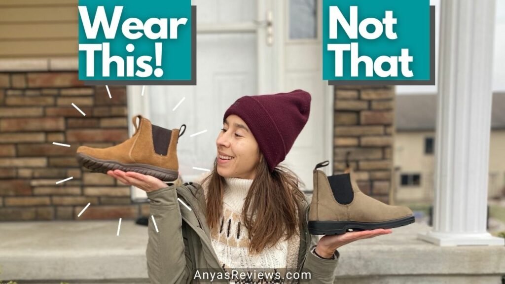 A woman holding up two pairs of shoes, the Lems Chelsea barefoot boot with the text "wear this" in one hand and Blundstones chelsea boot with the text "not that" in the other hand