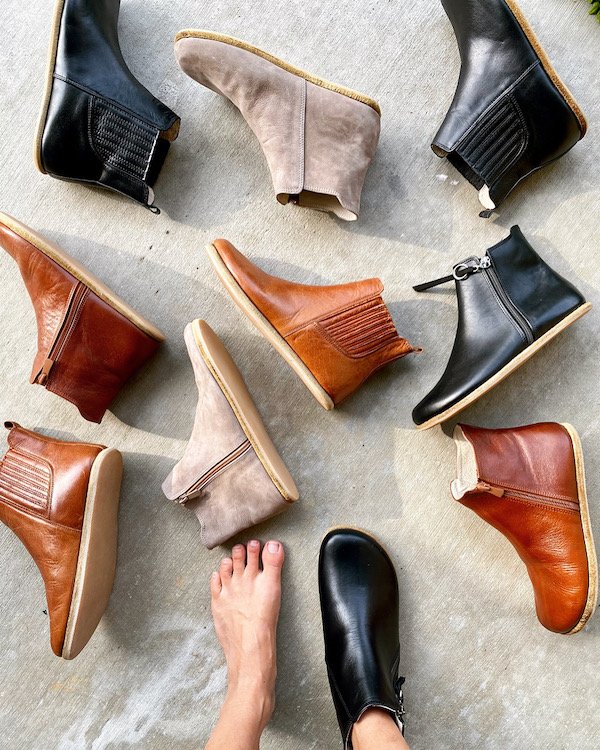 A flat lay of different Designed by Anya Rosa & Lila stylish barefoot boots for women in different colors laying on the ground