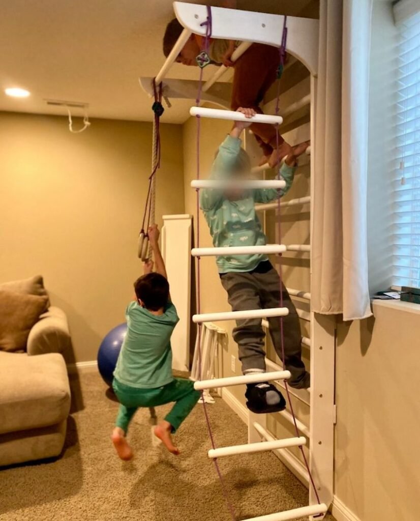 Kids playing on an indoor home jungle gym