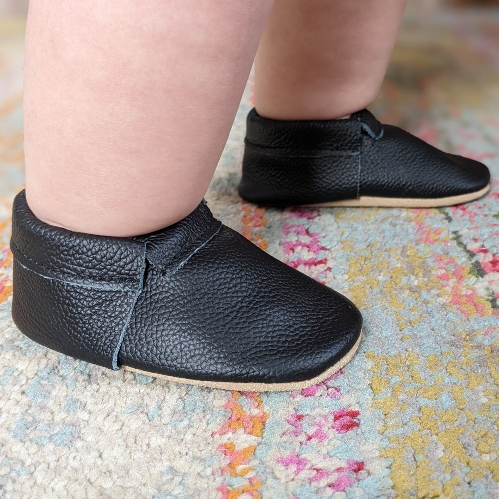 Bird Rock baby black leather affordable moccasins for baby's first barefoot shoes. Great for crawlers and new walkers