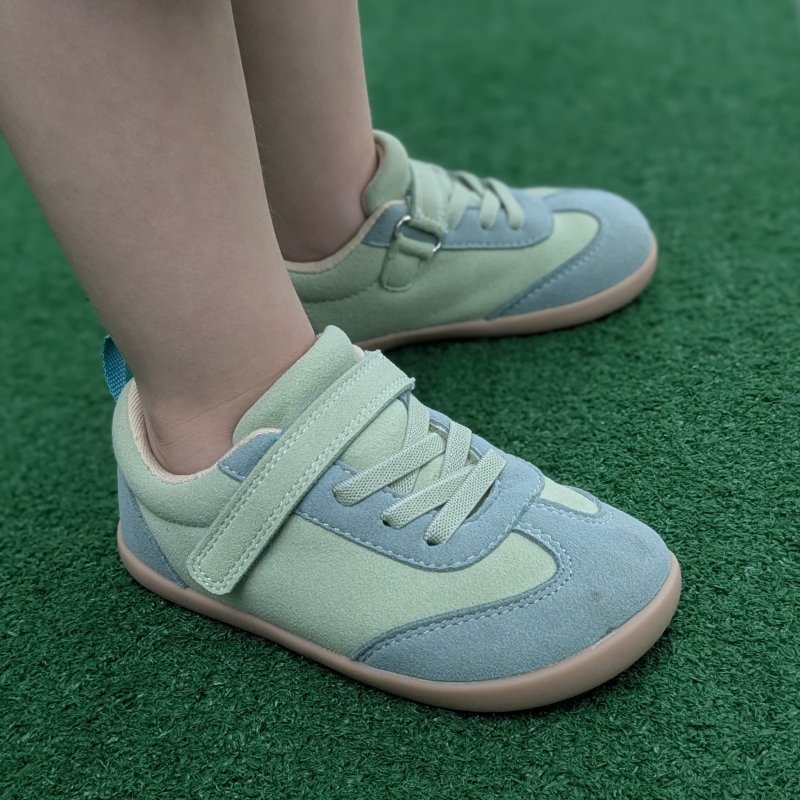 Side close up of a young toddler's feet in Ten Little vegan Retro suede barefoot sneakers for little kids