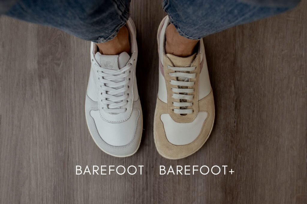 A top down view of a pair of feet wearing Groundies Orlando barefoot sneakers. On the left the person is wearing Barefoot fit, and on the right she is wearing Barefoot+ which has a wider toe box.