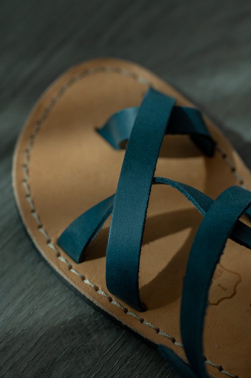 a close up of the leather straps on a pair of barefoot sandals from Crupon sandals to show the quality leather