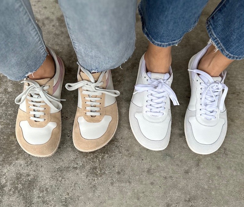 two people standing side by side wearing Groundies Orlando barefoot sneakers in wide and regular