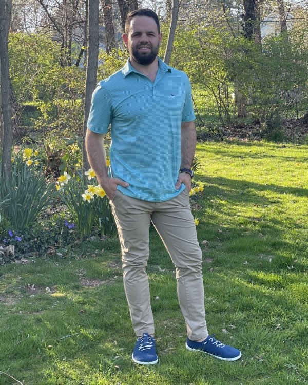 Full body photo of a man in a polo and khakis wearing stylish Be Lenka Elevate, barefoot breathable sneakers on zero drop flexible outsole.