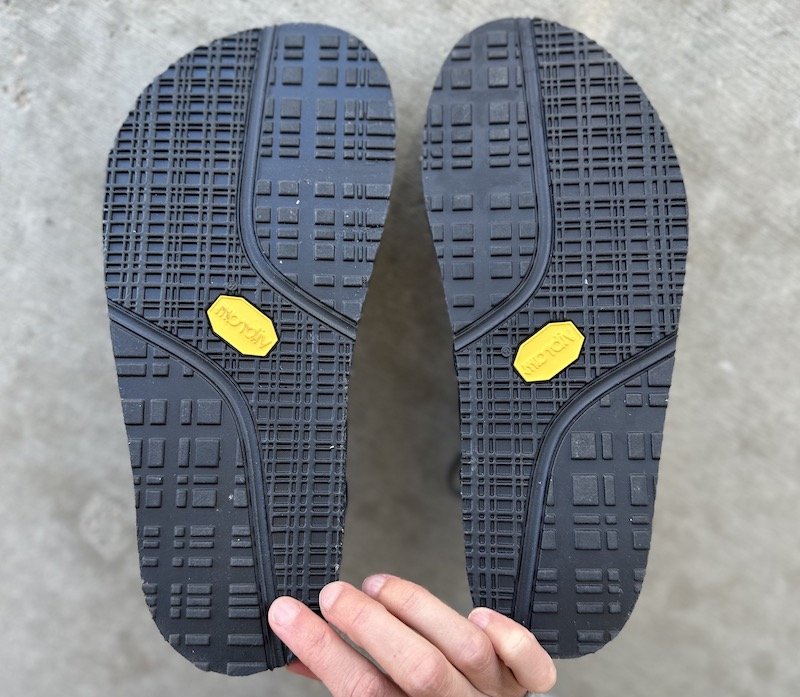 A top down view of the outsoles of Softstar Oxfords in Wide width with a foot shaped toe box next to the regular width which is narrower