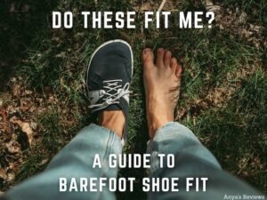 A top down view of a pair of feet standing on grass with one barefoot foot shaped shoe on and one foot bare. With the text "Do these fit me? A Guide to Barefoot Shoe Fit, Anya's Reviews" written over it