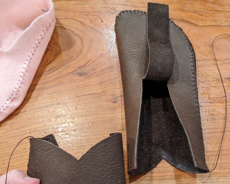 A pair of DIY Earthing Moccasins with the opening cut and the heel curve formed before stitching