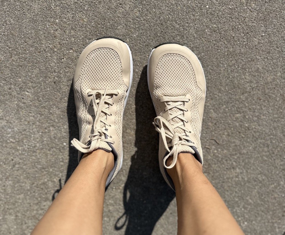 A top down view of Bahe's grounding barefoot running shoe's in sand color to show it's natural foot shape.