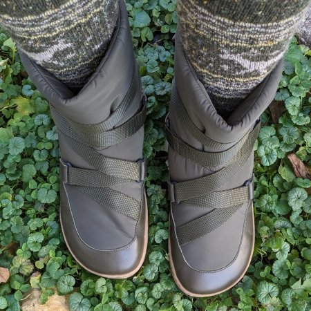 Top overhead view of a pair of legs in thick socks  standing on clover wearing Shapen Frosty warm winter nylon boots for casual cold wear