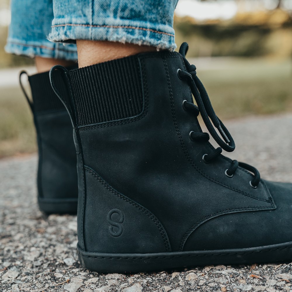 Close up of the back and side of Shapen Urbaneer casual barefoot boots for fall and winter. The elastic cuff around the back and pull table are shown with the soft comfortable leather uppers.