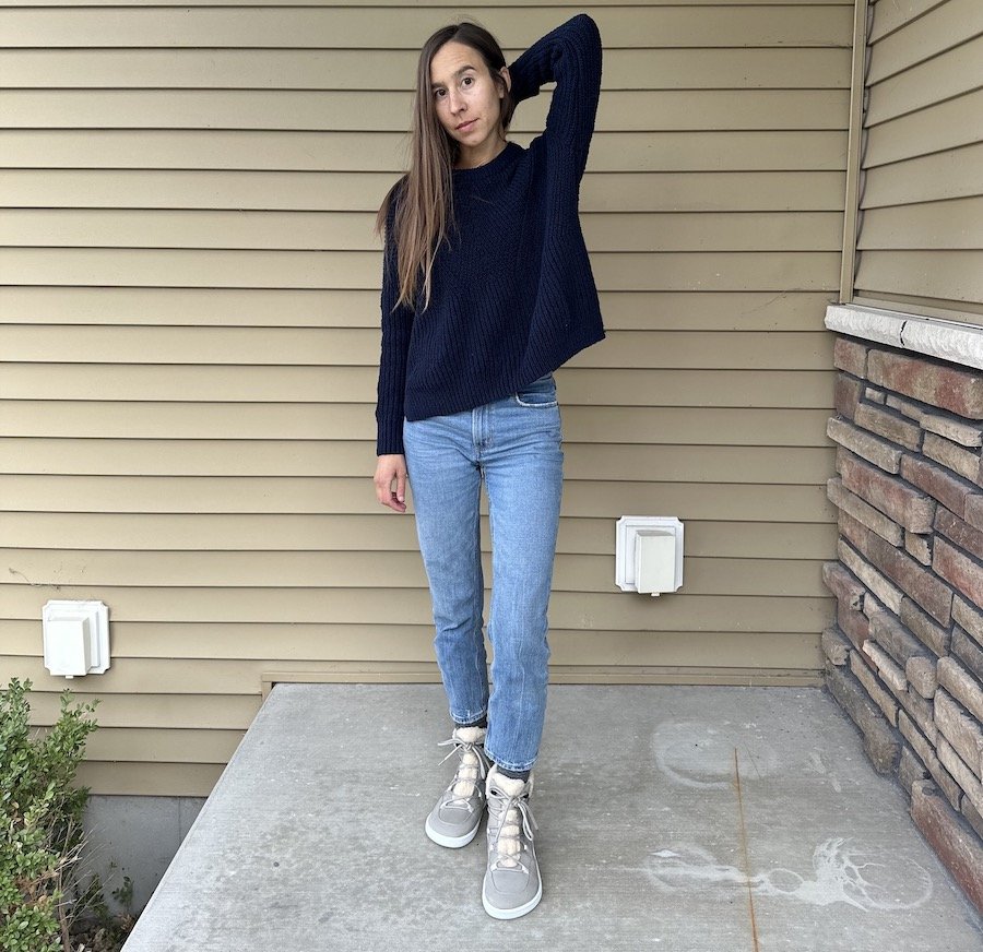 Full body photo of a woman with long brown hair wearing jeans and a sweater pair with light grey Be Lenka Bliss warm winter barefoot boots for extra wide feet