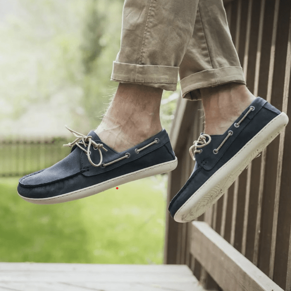 A pair of feet in a Gaucho Ninja barefoot deck boat shoes with a wide toe box and flexible outsole