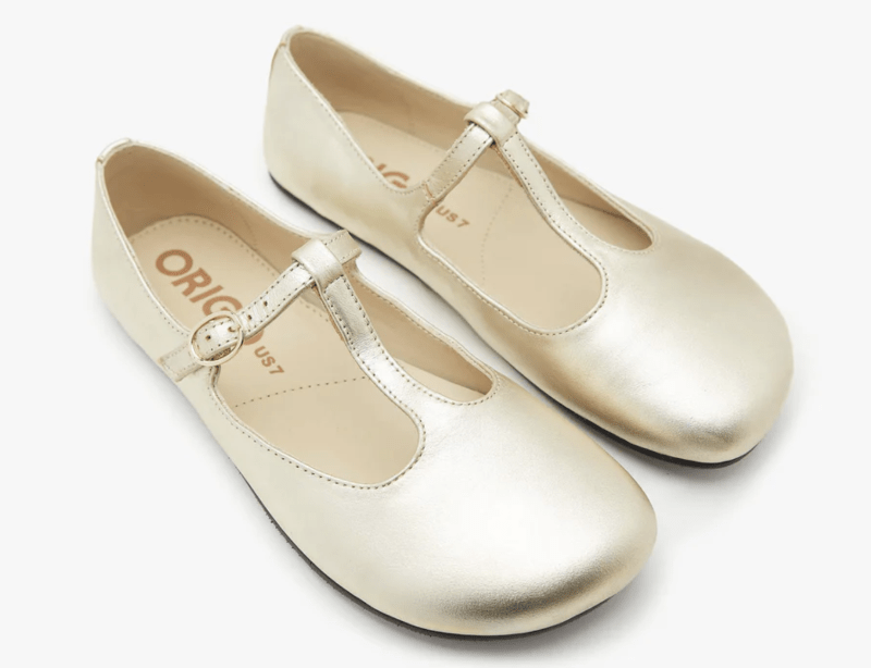 Gold leather origo t-bar mary jane flats with a wide toe box and flat flexible outsole