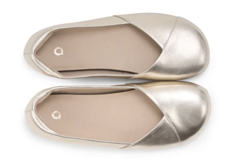 Xero Phoenix Flats in Metallic gold leather stock photo shown straight down of the wide toe box
