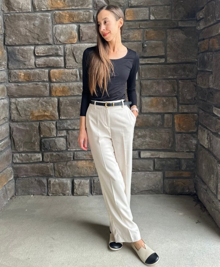 A woman wearing dress pants and the Be Lenka Rosaluna barefoot flats beige with a black toe cap