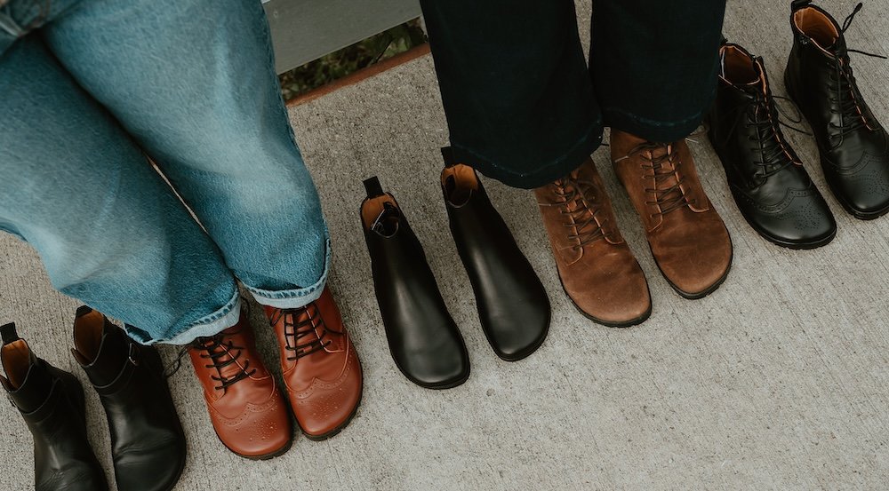 An angled top down view of a row of Zaqq Barefoot boots showing the high quality leather, attractive style, and foot shaped toe box