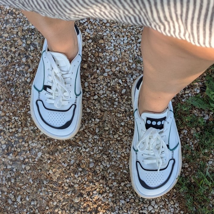 A person walking in a pair of Dada Brand extra wide sneakers with a trendy look, wide toe box, and zero drop outsole